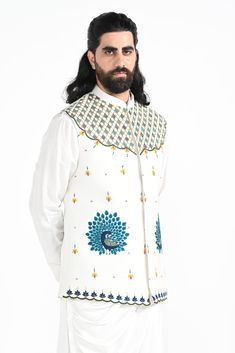 A dewy mist coloured Rajasthani inspired peacock motif hand embroidered nehru jacket with a cowl draped kurta made of bamberg raw silk. Paired with white slim fit Pant Pajama. Color of the actual garment may vary due to lighting conditions during the shoot.

Size Chart For Men





	
	
					Men's Size Chart
		

		
		
						
				Size Chart For Men
				Custom Size Measurement Guide
			
			
				
				
				Custom Size Measurement Guide
1. Take your measurements at ease…don’t hold your breath!
2. Be a Spring Festive Kurta With Motifs, Silk Nehru Jacket With Intricate Embroidery For Festive Occasions, Festive Silk Nehru Jacket With Intricate Embroidery, Transitional Silk Nehru Jacket With Intricate Embroidery, Transitional Nehru Jacket With Intricate Embroidery In Silk, Traditional Cotton Nehru Jacket For Festivals, Designer Embroidered Nehru Jacket In Raw Silk, White Resham Embroidered Nehru Jacket In Cotton Silk, White Cotton Silk Nehru Jacket With Resham Embroidery