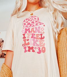 a blonde woman wearing a t - shirt that says man i feel like a bride