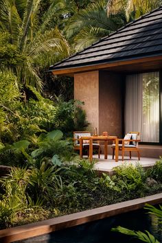 an outdoor dining area with table and chairs