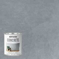 a can of paint sitting on top of a gray floor next to a white wall