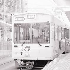 a black and white photo of a train at a station