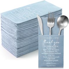 a stack of blue napkins with silverware next to it on top of each other