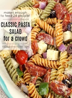 a pasta salad in a bowl with the words, make enough to feed 24 people classic pasta for a crowd