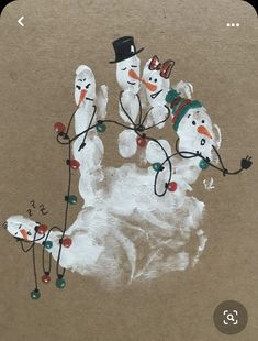 an image of snowmen with hats and lights on their hands painted on brown paper