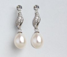 "These earrings are made with Grade AAA 8-9 mm tear drop freshwater pearls, sterling silver and crystal rhinestones. Amazing quality natural pearls! Tarnish resistant sterling silver!! . Each earring measures 2.8 cm (1 1/8 \")  long. For more bridal earrings, please visit : http://www.etsy.com/shop/WearableArtz?section_id=6869826" Silver Pearl Bridal Earrings Pear-shaped, Silver Pear-shaped Pearl Bridal Earrings, Pear-shaped Pearl Bridal Earrings In Silver, Elegant Silver Pearl Earrings With Pear Shape, Silver Pearl Teardrop Drop Earrings, Elegant Silver Pear-shaped Pearl Earrings, Teardrop Pearl Earrings For Anniversary, Silver Teardrop Pearl Bridal Earrings, Silver Drop Bridal Earrings With Pearl Charm