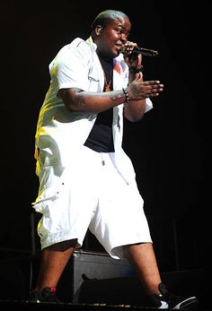 the rapper performs on stage at an event