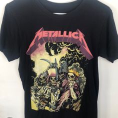 a black shirt with an image of two skeletons on it and the words metallicica