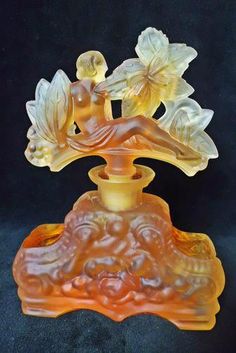 an orange glass figurine with flowers on it