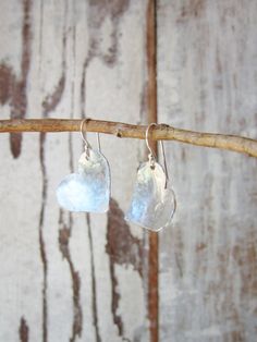 "I cut these two free form hearts from a sheet of sterling silver metal and hammered them to create these rustic earrings. They are coated to prevent tarnishing. The hearts have a slight curve to them to pick up shine from the hammered indensions. They measure 1 1/4\" in length from the top of the sterling silver earwire. Very lightweight and comfortable for all day wear. See the longer heart version here: https://www.etsy.com/listing/129416439/valentines-gift-sterling-silver-heart?ref=shop_home Hammered Silver Heart Jewelry, Heart-shaped Hammered Sterling Silver Jewelry, Sterling Silver Earrings For Anniversary Gift, Silver Sterling Silver Earrings For Anniversary Gift, Silver Heart Earrings For Anniversary Gift, Sterling Silver Heart Earrings For Anniversary, Silver Heart Shaped Earrings For Anniversary, Silver Heart Earrings For Anniversary, Sterling Silver Heart Earrings