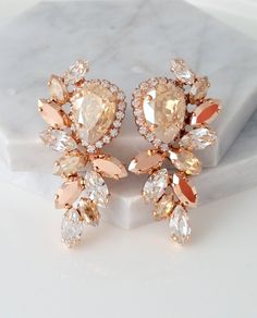 "✤ I can make these earrings with many available other colors to match your wedding party scheme (or any available other occasion). Please just contact me. ✤ Matching bracelet here: https://etsy.me/2m0OSHZ https://etsy.me/2lZU8LW https://etsy.me/2lzB0Ef https://etsy.me/2lYNyW2 https://etsy.me/2lEgimz ✤ Matching necklace here: https://etsy.me/2kuVQ7F https://etsy.me/2lyBOcu ✤ Matching hair comb here: https://etsy.me/2lE2oRm ✤ Available in other metal finishes at the drop-down menu. ✤ Made with pr Sparkling Rose Gold Bridal Earrings For Party, Sparkling Rose Gold Crystal Wedding Earrings, Sparkling Rose Gold Crystal Earrings For Wedding, Bridal Stud Earrings, Rose Gold Statement Earrings, Blue Bridal Earrings, Champagne Earrings, Random Products, Bridal Earrings Studs