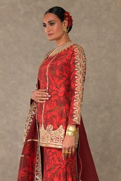 Red gulmohar print kurta, accentuated with haath-phool and kamal motifs in dori, sitara and dabka work. Paired with gulmohar print sharara with shajara motif in dori, sitara and dabka work and edged with kinari.  Comes along with a dupatta, embellished with  haath-phool border and edged with kinari. - Aza Fashions Traditional Red Sharara For Ceremonial Occasion, Bollywood Style Ceremonial Sharara With Resham Embroidery, Ceremonial Sharara For Diwali With Resham Embroidery, Designer Red Anarkali Set With Meenakari, Designer Red Meenakari Anarkali Set, Red Anarkali Set With Meenakari For Eid, Red Meenakari Anarkali Set For Eid, Red Anarkali Set For Ceremonial Festivals, Red Ceremonial Anarkali Set For Festivals