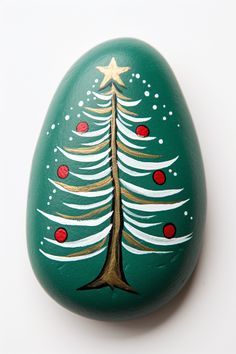 a painted rock with a christmas tree on it