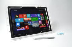 a tablet computer sitting on top of a table next to a pen