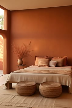 A serene bedroom with walls bathed in terracotta, complemented by a white ceiling. The room features a platform bed with terracotta and white linens, a bamboo nightstand, and a terracotta ceramic vase. A terracotta and beige woven wall hanging and a matching ottoman complete the Zen atmosphere. Diy Boho Interior, Terracotta Theme Bedroom, Clay Bedroom Walls, Modern Orange Bedroom, Terracotta Room Aesthetic, Dessert Interior Design, Terracotta Bedroom Aesthetic, Dusty Orange Bedroom