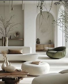 a living room filled with white furniture and lots of plants in vases on the tables