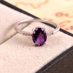 This Sterling Silver Ring features an Elegant Art With Natural Amethyst Gemstone. The cavity is made from genuine solid 925 sterling silver and stamped as S925. This Jewelry is Lead free and Rhodium plated to resist scratches and tarnish. ITEM DESCRIPTION Item Code: JARG335/7 Metal: 925/92.5 Sterling Silver Gemstone: Genuine Natural Amethyst Gemstone Shape: Oval Gemstone Size: 6 X 8 MM Oval Surrounded Tiny Stones: Zircon Ring Length: 8 MM Ring width: 6 MM Weight: 1.7 gm approx **Keep the jewelry Oval Amethyst Ring, February Birthstone Ring, Purple Ring, Purple Rings, Ring Purple, Tiny Rings, Midi Ring, Gold Earrings Designs, Alternative Engagement Rings