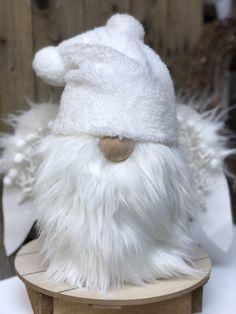 a white stuffed animal wearing a hat with words above it that read snow white angel gnome diy