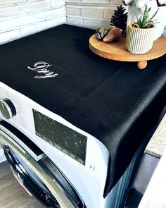 a washer and dryer sitting on top of a counter