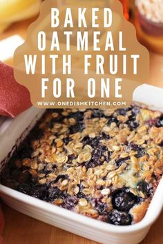 baked oatmeal with fruit for one in a white dish on a wooden table