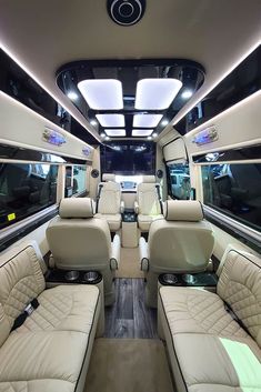 the interior of a luxury vehicle with leather seats and lights in front of windows on both sides