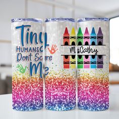 two personalized tumbles with crayons on the side and lettering that says tiny humans don't scare me