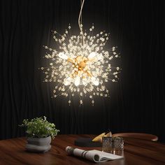 a light that is on top of a wooden table next to a potted plant