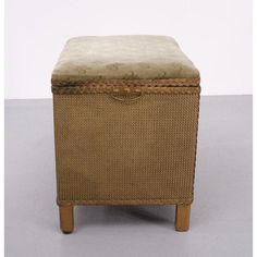 an upholstered foot stool with a cushion on top