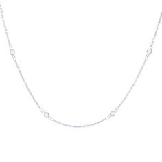 A staple in any jewelry collection this necklace features round brilliant cut diamonds in bezel stations. Elegant Bezel Setting Station Necklace, Elegant Bezel Set Station Necklace, Classic Station Necklace With Bezel Setting For Anniversary, Anniversary Bezel Setting Station Necklace, Classic White Gold Station Necklace With Bezel Setting, Classic Bezel Set Station Necklace For Anniversary, Classic Bezel Setting Station Necklace, Classic Necklace With Smooth Bezel, Luxury Cubic Zirconia Solitaire Necklace With Bezel Setting