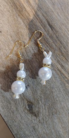 Order by MONDAY, March 26th, 2021 to guarantee delivery before Easter (without rush shipping charges). Adorable freshwater pearl bunny earrings shout Easter.  Just in time for Easter these adorable bunny earrings come in several varieties, just specify which you want in your order.  Adorable for yourself or a GREAT gift idea!  Perfect for adults or girls, you just can't go wrong!     #1 silver collar #2 gold collar #3 no collar  all styles come with your choice of: (enter selection under personalization) gold hypo-allergenic ear hooks silver hypo-allergenic ear hooks plastic no metal ear hooks or gold or silver post w/backs   Earrings: 1-1/2" long with silver plated earring hook wires   These were designed by my grand-daughter and myself as we launch our jewelry making endeavor. We are bui Handmade White Pearl Earrings For Gift, Handmade Pearl Beaded Earrings As Gift, Handmade Pearl Earrings Gift, Handmade Pearl Earrings As Gift, Handmade Pearl White Beaded Earrings Gift, Gift Pearl Earrings With Ear Wire, Gift Pearl Earrings With Round Beads, Pearl White Earrings For Gift, Easter Jewelry Gift For Pierced Ears