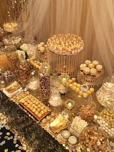 a table topped with lots of desserts and candies