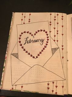 an open book with the word february written on it and a heart shaped envelope in the middle