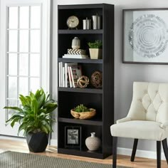 a living room with a chair and a book shelf