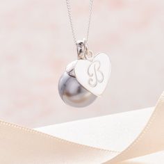 Initial necklace with pearl, pearl monogram necklace, letter necklace with pearl, sterling silver initial pendant, pearl bridesmaid necklace.__________________________________________Silver initial necklace featuring a 12 mm soft grey Swarovski pearl pendant hung along side a sterling silver heart charm hand stamped with your choice of letter in a beautiful scrolling upper case font.  A timeless classic, this personalised pearl necklace is is the perfect gift to gift for any gifting occasion inc Necklace With Pearl, Bridesmaid Pearls, Sterling Silver Initial, Silver Caps, Monogram Necklace, Bridesmaid Necklace, Initial Pendant, Swarovski Pearls, Letter Necklace