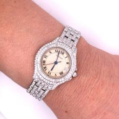 Vintage Women's 18 karat white gold Cartier watch with quartz movement and original Cartier factory diamonds. Movement Caliber 687, water-resistant, and set with over 3 carats in round-cut diamonds.   Stamped: "Cartier", "Quartz", "18K", "387907 000180", and "Swiss made".   Watch: - Brand: Cartier  - Style: Ballon - Gender: Ladies  - Movement: Quartz  - Water-Resistant (1 ATM) - Serial #: 387907 000180 - Weight: 70.00 grams - Caliber 687  Case/Dial:  - Case Material: 18k White Gold - Hour Markers: Roman Numeral  - Dial Color: White  - Case Width: 28mm  - Bezel Material: 18k White Gold - Crystal: Scratch-resistant sapphire crystal   Bracelet:  - Closure: Double Fold Over Clasp (Hidden) - Length: 7 inches  - 18k White Gold   Diamonds: - Total Carat Weight: 328 diamonds, 3.28 carats total (ap Cartier Diamond Watch With Brilliant Cut, Elegant Diamond Watch With Brilliant Cut And Round Dial, Classic Diamond White Round Diamond Watch, Elegant Round Diamond Watch With Brilliant Cut, Elegant Brilliant Cut Diamond Watch, Cartier Diamond Watch For Wedding, Luxury Platinum Diamond Watch With Brilliant Cut, Diamond Watch With Single Cut Diamonds, Formal Diamond Watch With Brilliant Cut