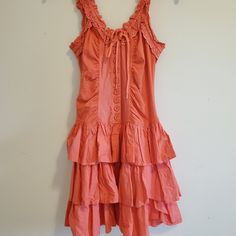 Betsey Johnson Coral Dress With A Cupcake Silhouette. So Cute! Has Ruching On The Neckline With A Tie Front That's Adjustable. Button-Down Front Leads Into A Tiered Ruffle Hem. Size Xs But Can Also Definitely Fit A S As It Has Stretch. In Perfect Condition! Fitted Tiered Cotton Ruffle Dress, Spring Tiered Dresses With Buttons, Spring Tiered Button Dress, Red Ruffled Dress For Daywear, Red Ruffled Mini Dress For Daywear, Knee-length Ruffle Mini Dress, Cupcake Silhouette, Betsey Johnson Dresses, Coral Dress