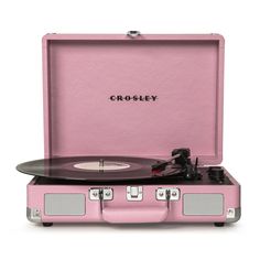 a pink suitcase with a record player in it and the word crosley on top