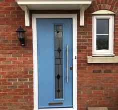 a blue front door on a brick house