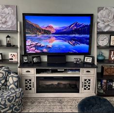 a flat screen tv sitting on top of a entertainment center