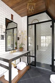 the bathroom is decorated in black and white with wood trimmings, tile flooring,