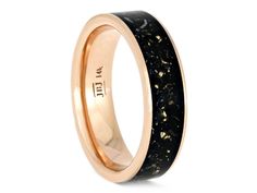 a black and gold wedding ring with an antelope inlay