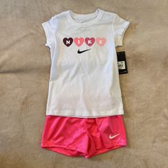 Nike Girls Outfit Size 6. Short Sleeve Shirt And Shorts. White Shirt And Pink Shorts. Brand New! Cute White Short Sets, Playful Nike Cotton Bottoms, Nike White Short Sleeve Sets, Playful Cotton Bottoms By Nike, White Nike Summer Sets, Nike White Summer Sets, White Nike Casual Sets, Nike White Casual Sets, Nike Casual White Sets