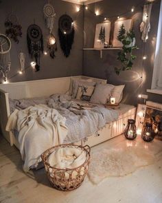 a bedroom with lights strung from the ceiling and decorations on the wall, along with an unmade bed