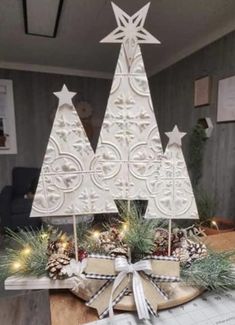 a wooden christmas tree sitting on top of a table