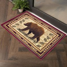 a bear rug on the floor in front of a door with a potted plant