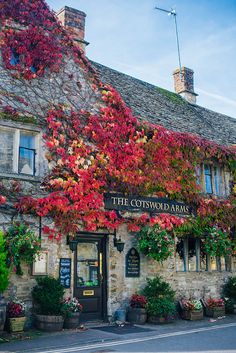 the cotswold arms hotel in autumn with red leaves on it's facade