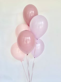 a bunch of pink and white balloons in a vase