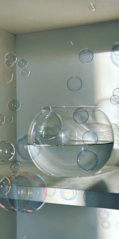 soap bubbles floating in a bowl on top of a shelf