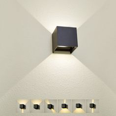 an image of a modern light fixture on the wall with four lights in front of it