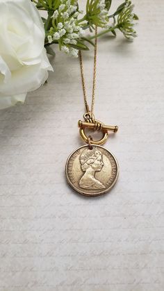 "For your favorite Australian, this necklace will be a treasure! Your choice of a silver-toned Australian 50-cent coin with the image of Queen Elizabeth on one side and an emu and kangaroo on the reverse side or a gold-toned Australian dollar coin with Queen Elizabeth on the front and kangaroos on the reverse side. The coin dangles from either a 16\" or 18\" matching chain with a front toggle closure. Welcome to Recycled Finery!  I repurpose old jewelry, coins, beads, vintage buttons, watch part Vintage Charm Coin Necklace With Round Pendant As Gift, Vintage Charm Medallion Coin Necklace As Gift, Medallion Coin Necklace With Vintage Charm As A Gift, Vintage Charm Medallion Coin Necklace For Gift, Silver Toggle Necklace With Coin Pendant As Gift, Vintage Medallion Coin Necklace As A Gift, Antique Coin Necklace With Vintage Charm As Gift, Antique Coin Necklace With Vintage Charm For Gift, Antique Style Coin Necklace With Vintage Charm For Gifts