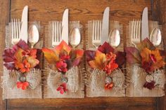 the forks are decorated with fall leaves and burlap